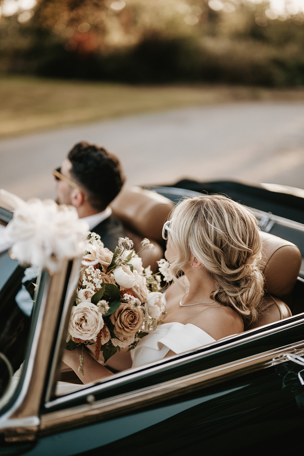 Bride and groom golden hour kiss by vintage car — fashion-editorial wedding photography